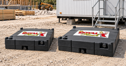 Royal Flush Tanks Beside a Jobsite Trailer